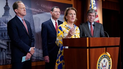 In this photo taken Thursday, May 27, 2021, Sen. Shelley Moore Capito, R-W.Va., the GOP's lead negotiator on a counteroffer to President Joe Biden's infrastructure plan, speaks at a news conference as she is joined by, from left, Sen. Pat Toomey, R-Pa., Sen. John Barrasso, R-Wyo., chairman of the Senate Republican Conference, and Sen. Roy Blunt, R-Mo., at the Capitol in Washington.