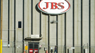In this Oct. 12, 2020 photo, a worker heads into the JBS meatpacking plant in Greeley, Colo.