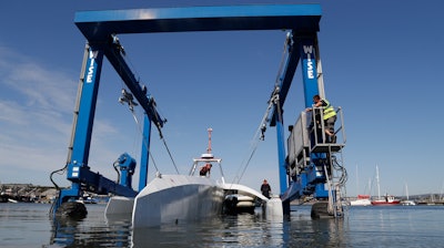 In this Monday, Sept. 14, 2020 file photo, technicians lower the Mayflower Autonomous Ship into the water at its launch site for it's first outing on water since being built in Turnchapel, Plymouth south west England.