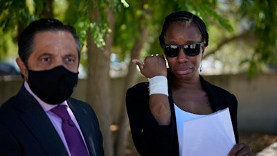 Lawyer Javier Villalba, left and John McAfee's wife Janice speak briefly with journalists on leaving the Brians 2 penitentiary center in Sant Esteve Sesrovires, near Barcelona, northeast Spain, Friday, June 25, 2021.