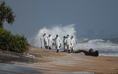 Sri Lankan navy soldiers collect debris that washed ashore from burning ship MV X-Press Pearl anchored off Colombo port at Kapungoda, out skirts of Colombo, Sri Lanka, Monday, May 31, 2021. The fire on the Singapore-flagged ship has been burning since May 20, ravaging the ship. Debris from the burning ship that has washed ashore is causing severe pollution on beaches.