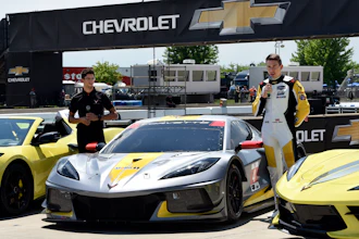 Drivers Jordan Taylor, left, and Tommy Milner attend a news conference while standing next to a Corvette C8.R race car Wednesday, June 9, 2021, at Raceway at Belle Isle in Detroit.