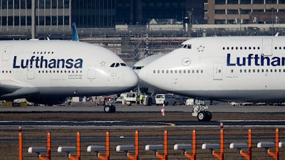 In this Feb. 14, 2019 photo, an Airbus A380, left, and a Boeing 747, both from Lufthansa airline pass each other at the airport in Frankfurt, Germany.