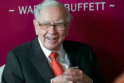 In this May 5, 2019, file photo Warren Buffett, Chairman and CEO of Berkshire Hathaway, smiles as he plays bridge following the annual Berkshire Hathaway shareholders meeting in Omaha, Neb. Warren Buffett made a $4.1 billion annual philanthropic contribution and said he’s halfway through his goal of giving away most of his money. The billionaire investor also said he is stepping down as trustee of the Bill and Melinda Gates Foundation as he exits all other corporate boards.