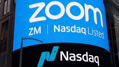 This April 18, 2019, file photo shows a sign for Zoom Video Communications ahead of their Nasdaq IPO in New York. Zoom is still booming, raising prospects that the video-conferencing service will be able to sustain its momentum, even as the easing pandemic lessens the need for virtual meetings.