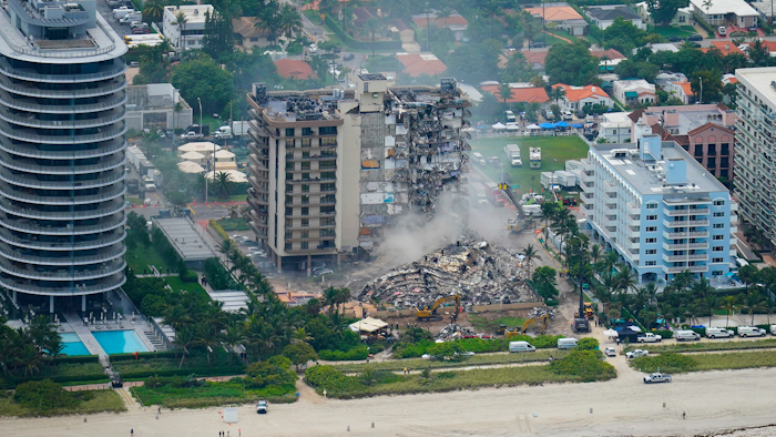 In this Friday, June 25, 2021, file photo, rescue personnel work in the rubble at the Champlain Towers South Condo, in Surfside, Fla. Even as the search continues over a week later for signs of life in the mangled debris of the fallen Champlain Towers South, the process of seeking answers about why it happened and who is to blame is already underway in Florida's legal system.