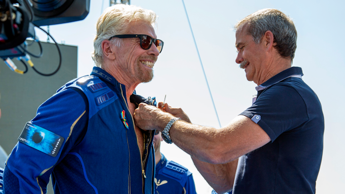 Virgin Galactic founder Richard Branson, left, receives a Virgin Galactic made astronaut wings pin from Canadian astronaut Chris Hadfield after his flight to space from Spaceport America near Truth or Consequences, N.M., Sunday, July 11, 2021.