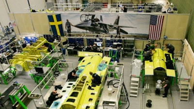 Saab employees work on an aft airframe section for the T-7A Red Hawk trainer for the United States Air Force.