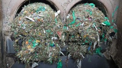 Plastic residue being filtered out of food waste collected in Norway after fermentation to biogas and soil fertilizer.
