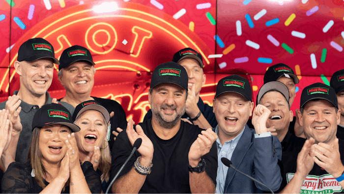 Krispy Kreme CEO Mike Tattersfield, center, applauds during the company's IPO at the Nasdaq Opening Bell on Thursday, July 1 in New York.