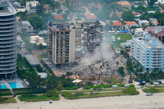 In this Friday, June 25, 2021, file photo, rescue personnel work in the rubble at the Champlain Towers South Condo, in Surfside, Fla. Even as the search continues over a week later for signs of life in the mangled debris of the fallen Champlain Towers South, the process of seeking answers about why it happened and who is to blame is already underway in Florida's legal system.