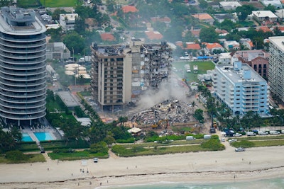 In this Friday, June 25, 2021, file photo, rescue personnel work in the rubble at the Champlain Towers South Condo, in Surfside, Fla. Even as the search continues over a week later for signs of life in the mangled debris of the fallen Champlain Towers South, the process of seeking answers about why it happened and who is to blame is already underway in Florida's legal system.
