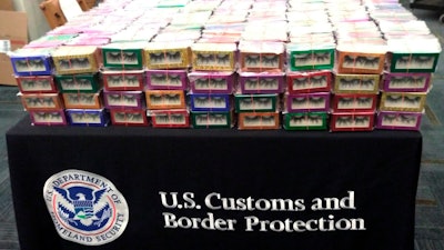 This photo provided by U.S. Customs and Border Protection shows boxes of long lashes seized Tuesday, July 6, 2021 at Louis Armstrong New Orleans International Airport. Three thousand pairs of false eyelashes have been seized by U.S. Customs and Border Protection agents after officials determined they were illegally imported from China to New Orleans. Agency spokesperson Matthew Dyman tells WVUE-TV that the four boxes of long lashes seized Tuesday were destined for a local beauty supply store.