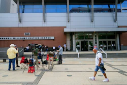Members of the media gather Monday, July 12, 2021, outside the justice center in Wilmington, Del.