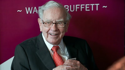 In this May 5, 2019, file photo Warren Buffett, Chairman and CEO of Berkshire Hathaway, smiles as he plays bridge following the annual Berkshire Hathaway shareholders meeting in Omaha, Neb.
