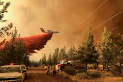 This photo provided by the Oregon Department of Forestry shows a firefighting tanker making a retardant drop over the Grandview Fire near Sisters, Ore., Sunday, July 11, 2021. The wildfire doubled in size to 6.2 square miles (16 square kilometers) Monday, forcing evacuations in the area, while the state's biggest fire continued to burn out of control, with containment not expected until November.