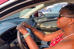 Jessica Pitts sits behind the wheel of a 2019 Lincoln MKC on the lot of Jack Demmer Lincoln in Dearborn, Mich., July 19, 2021.