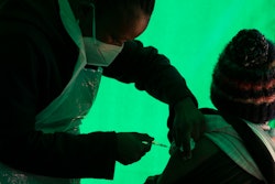 In this June 3, 2021 file photo an elderly patient receives a dose of the Pfizer COVID-19 vaccine, at a clinic at Orange Farm, near Johannesburg.