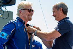 Virgin Galactic founder Richard Branson, left, receives a Virgin Galactic made astronaut wings pin from Canadian astronaut Chris Hadfield after his flight to space from Spaceport America near Truth or Consequences, N.M., Sunday, July 11, 2021.