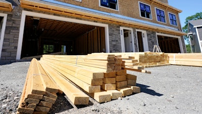 Lumber is piled at a housing construction site, Thursday, June 24, 2021, in Middleton, Mass. Home construction in the U.S. rose a strong 6.3% in June, another big swing in what has been an up-and-down year so far.