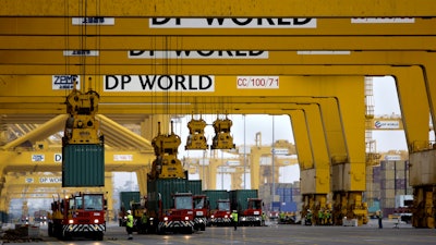 In this Feb. 8, 2009 file photo, cranes off load containers at the Jebel Ali port terminal 2, in Dubai, United Arab Emirates.