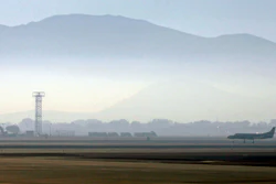 In this Sept. 24, 2014 file photo, smoke hangs over Reno-Tahoe International Airport as a plane takes off in Reno, Nev. A shortage of jet fuel, coupled with supply chain issues and an urgent demand from firefighting aircraft, continues to cause problems at airports around the West.