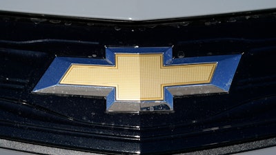 The Chevrolet logo is displayed at a Chevrolet dealership Sunday, Nov. 8, 2020, in Englewood, Colo. General Motors is telling owners of some older Chevrolet Bolts to park them outdoors and not to charge them overnight because two of the electric cars caught fire after recall repairs were made.