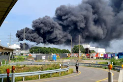 A dark cloud of smoke rises above the chemical park in Leverkusen, Germany, Tuesday, July 27, 2021. Firefighters from the site fire department are on duty.