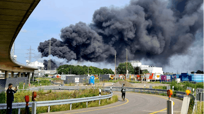 A dark cloud of smoke rises above the chemical park in Leverkusen, Germany, Tuesday, July 27, 2021. Firefighters from the site fire department are on duty.