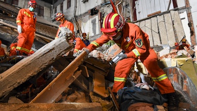 In this photo released by Xinhua News Agency, rescuers search for survivors at a collapsed hotel in Suzhou in eastern China's Jiangsu Province, Monday, July 12, 2021.