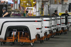 In this June 22, 2021, file photo, employees stand near Endurance truck beds during a media tour of the Lordstown Motors complex in Lordstown, Ohio. Lordstown Motors, an Ohio company that has come under scrutiny over the number of orders it claimed it had for the electric trucks that it wants to produce, acknowledged that it has received two subpoenas from federal regulators and that prosecutors in New York have opened an investigation.