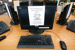 In this Aug. 22, 2019, file photo, signs on a bank of computers tell visitors that the machines are not working at the public library in Wilmer, Texas. The Associated Press has learned new details about a ransomware attack that affected roughly two dozen Texas communities two years ago.