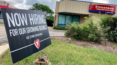 A hiring sign is displayed at Firestone Complete Auto Care store in Arlington Heights, Ill., Wednesday, June 30, 2021.