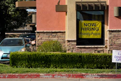 A hiring sign hangs in the window of a Taco Bell in Sacramento, Calif., Thursday, July 15, 2021.
