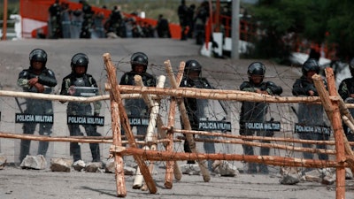 Mexican National Guard troops stand guard at Las Pilas dam after 2020 clashes with farmers in Chihuahua State.