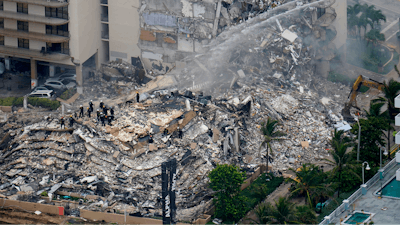 Rescue workers work in the rubble at the Champlain Towers South Condo in Surfside, Fla., in this Friday, June 25, 2021, file photo.