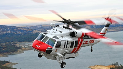 An S-70 FIREHAWK helicopter operated by CAL FIRE can transport firefighters, drop water on wildfires from its 1,000-gallon (3,785 liter) belly tank, and perform hoist rescues.