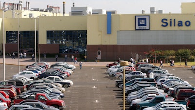 This Feb. 12, 2008 file photo shows the main entrance to the General Motors assembly plant in Silao, Mexico. Workers at the GM plant in Silao voted over two days, according to a Thursday, Aug. 19, 2021 statement from Mexico’s Labor ministry, to end a collective bargaining contract negotiated by an old guard union.