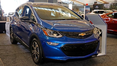 This Thursday, Feb. 13, 2020 file photo shows a 2020 Chevrolet Bolt EV on display at the 2020 Pittsburgh International Auto Show in Pittsburgh. General Motors is recalling all Chevrolet Bolt electric vehicles sold worldwide to fix a battery problem that could cause fires.