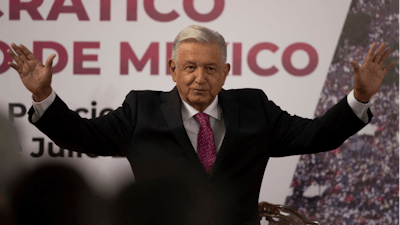 In this July 1, 2021 file photo, Mexican President Andres Manuel Lopez Obrador waves after giving a speech at a ceremony marking the third anniversary of his presidential election at the National Palace in Mexico City. Mexico's anti-monopoly regulator has on Wednesday, July 28, 2021, openly criticized President Lopez Obrador's plan to set a maximum price for cooking and heating gas.