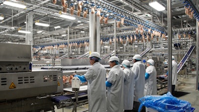 In this Dec. 12, 2019, file photo workers process chickens at the Lincoln Premium Poultry plant, Costco Wholesale's dedicated poultry supplier, in Fremont, Neb. Rural America continued to lose population in the latest U.S. Census numbers, highlighting an already severe worker shortage in those areas and prompting calls from farm and ranching groups for immigration reform to help alleviate the problem.