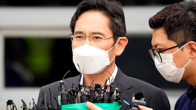 Samsung Electronics Vice Chairman Lee Jae-yong speaks to the media outside of a detention center in Uiwang, South Korea, Friday, Aug. 13, 2021. Embattled Samsung leader Lee apologized for causing public concern upon being paroled from prison Friday with a year left on his sentence for crimes related to the explosive corruption scandal that toppled South Korea’s previous president.