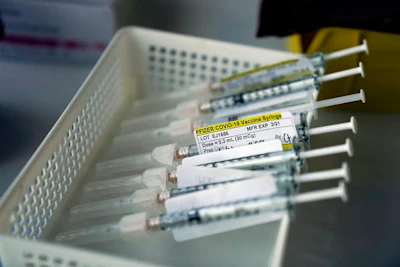 The last step of the process before inoculation involves diluting the vaccine with saline to create 0.3-milliliter doses.