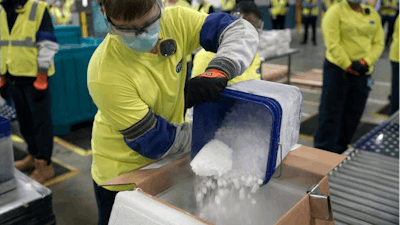 Pfizer’s custom boxes use dry ice to keep vaccine vials at ultra-cold temperatures.