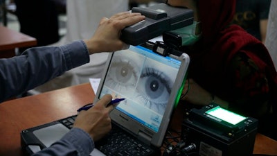 Before falling to the Taliban, the Afghan government made extensive use of biometric security, including scanning the irises of people like this woman who applied for passports.
