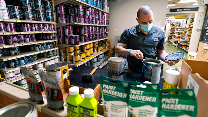 Billy Wommack, purchasing director at the W.S. Jenks & Sons hardware, opens a gallon of paint at the mixing station of the hardware store's paint department on Sept. 24 in northeast Washington.