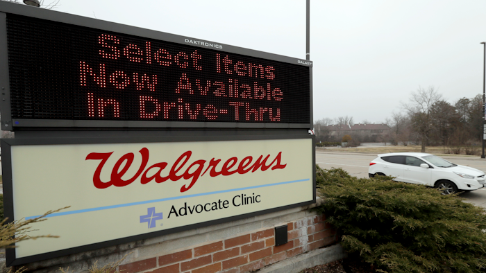 In this March 27, 2020, file photo, a Walgreens sign is displayed outside the store in Wheeling, Ill. Walgreens will hike starting pay to $15 an hour beginning in October, as employers across the United States continue boosting wages to attract workers.