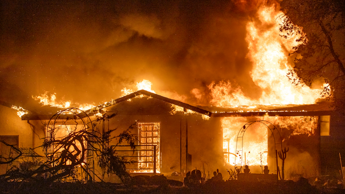 In this Sept. 27, 2020, file photo, a house burns on Platina Road at the Zogg Fire near Ono, Calif. Pacific Gas & Electric has been charged with manslaughter and other crimes, Friday, Sept. 24, 2021, in a Northern California wildfire last year that killed four people and destroyed hundreds of homes.