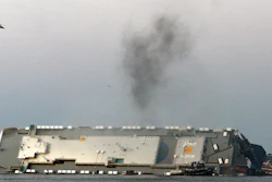 Smoke rises from a cargo ship capsized in the St. Simons Island, Georgia, sound, Sept. 8, 2019.