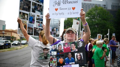 Lynn Wencus of Wrentham, Mass., during a protest at Purdue Pharma LLP headquarters in Stamford, Conn., Aug. 17, 2018.